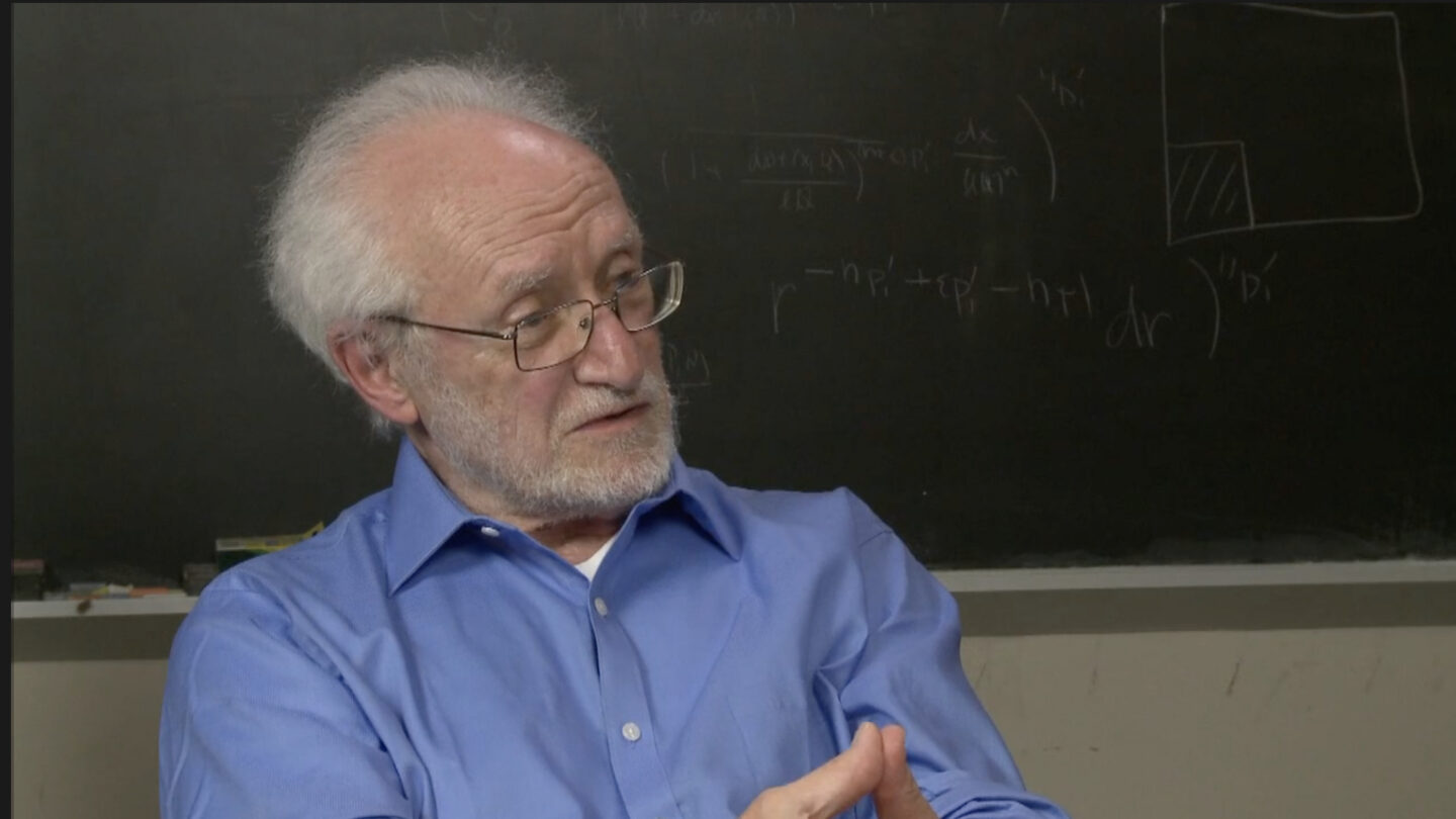 William Browder in front of a chalkboard