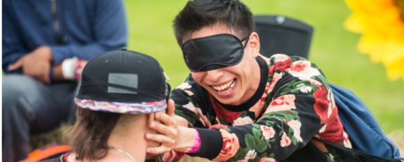 Would-be couples use touch to learn about their dates — a blindfolded man is touching another person's face