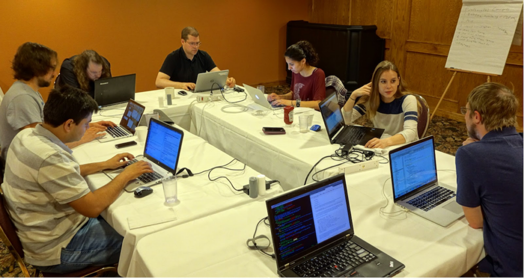 people sitting around computers working together