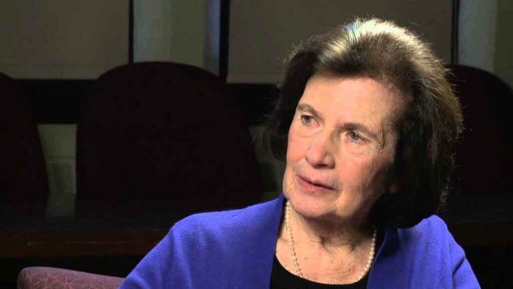 Vera Sos sits in a red chair