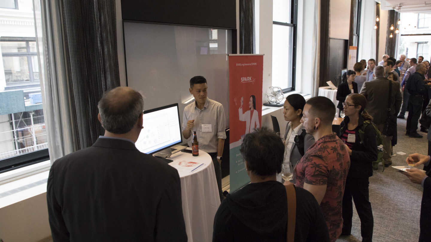 Image of attendees watch demo presentations of SFARI- and Simons Foundation-supported data analysis tools.