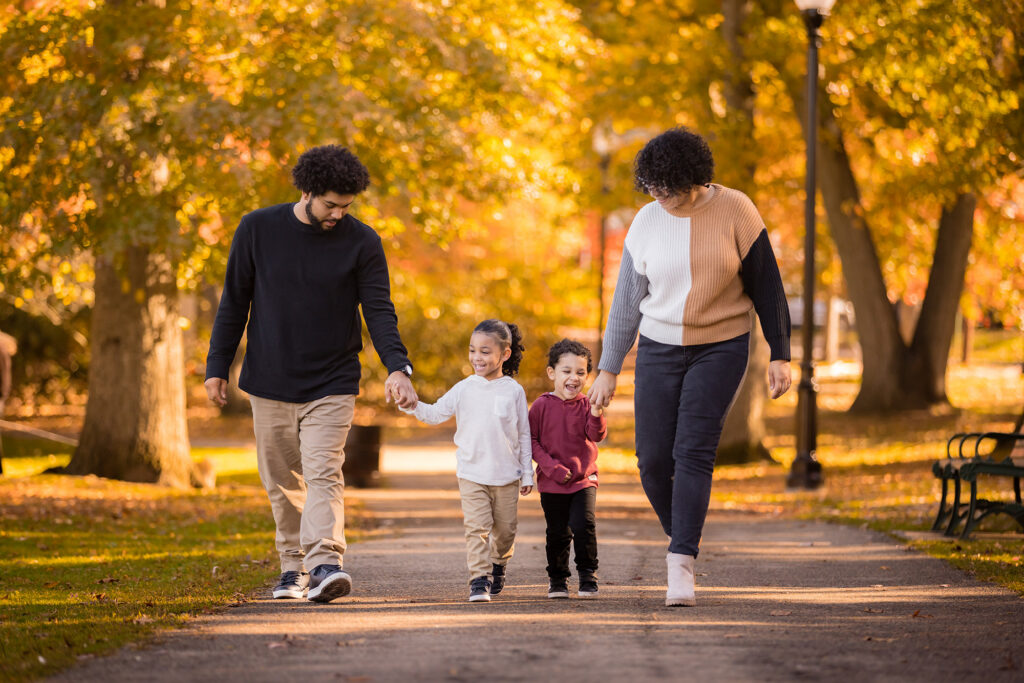 Two adults walking with two small children