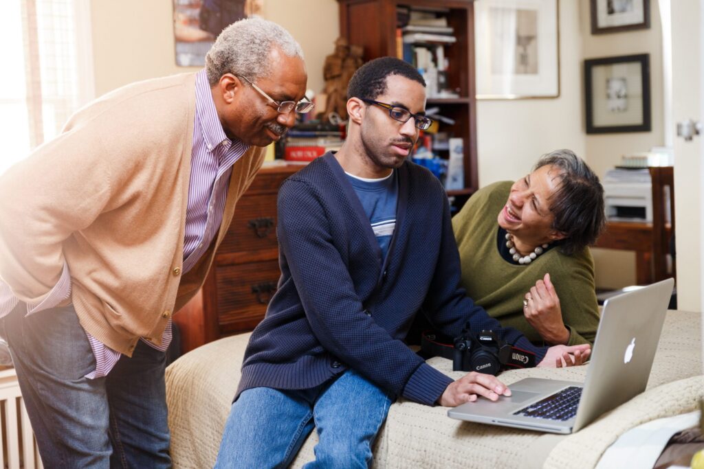 A man on a computer with his grandparents