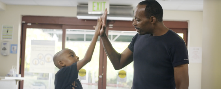 boy high fiving man