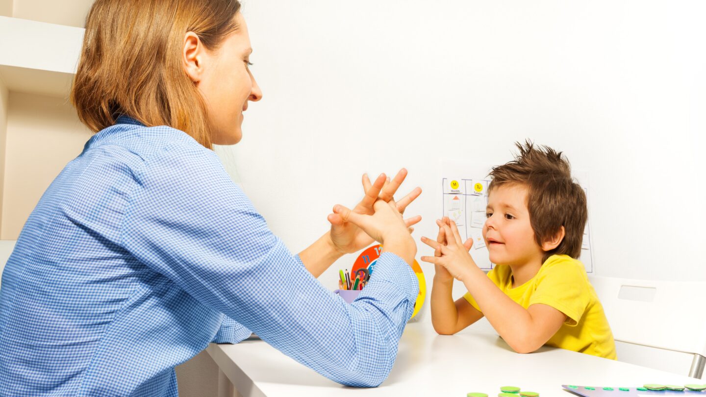Image of clinician assessing behavioral and motor skills in a young child.