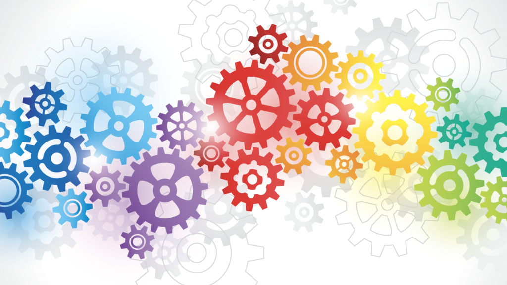 Colorful gears of various sizes interlock and overlap, forming a vibrant pattern across a white background. The gears range in color from blue and purple to red, yellow, and green, symbolizing diversity and collaboration.