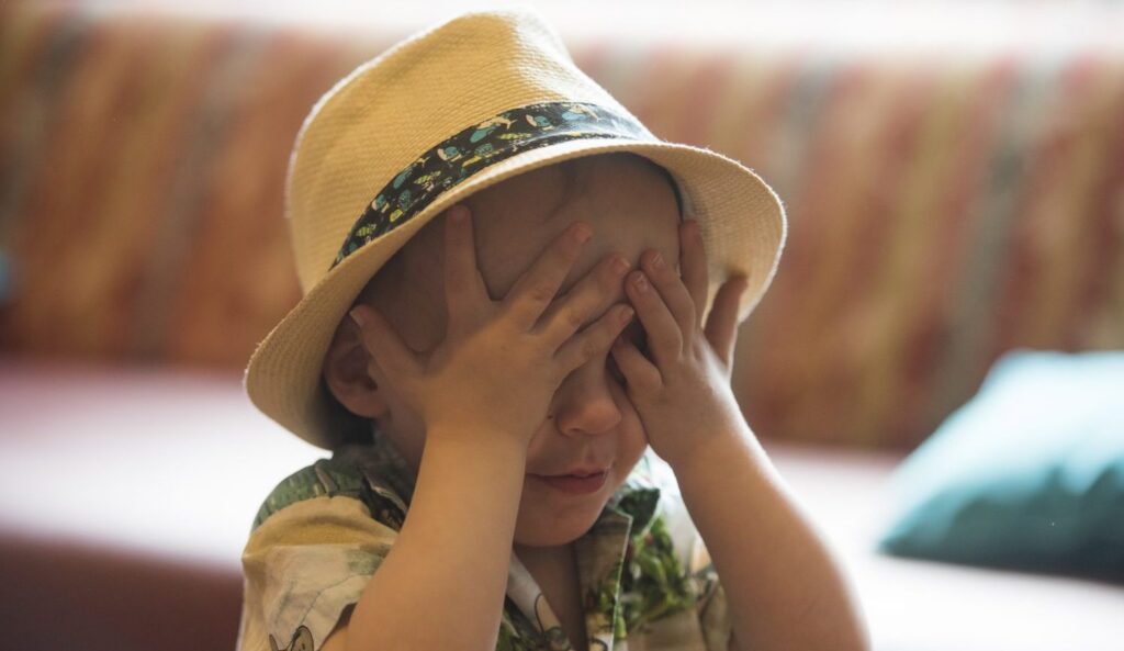 Image of child covering its eyes