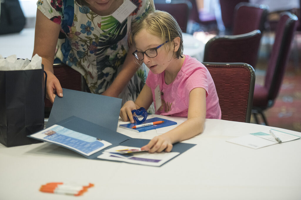 Image of woman helping girl