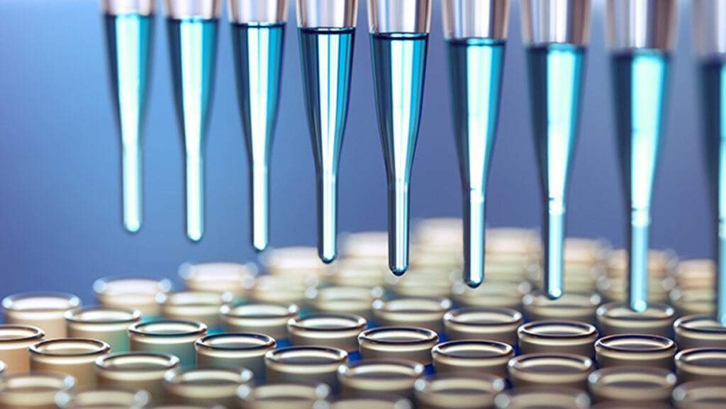 Close-up of several pipettes dispensing blue liquid into rows of small test tubes or vials in a laboratory setting.