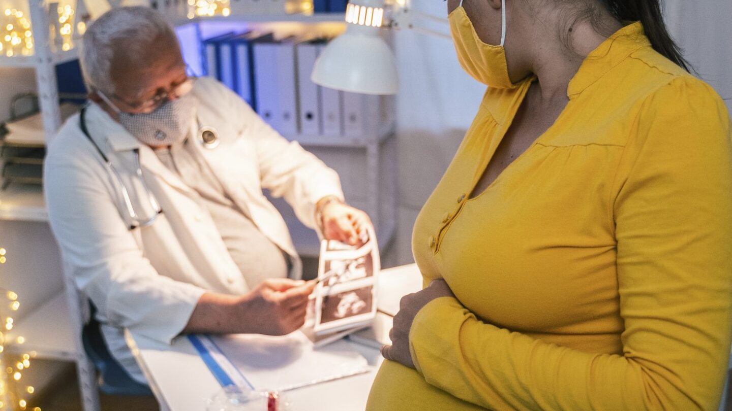 Image of pregnant woman getting a check up from a doctor