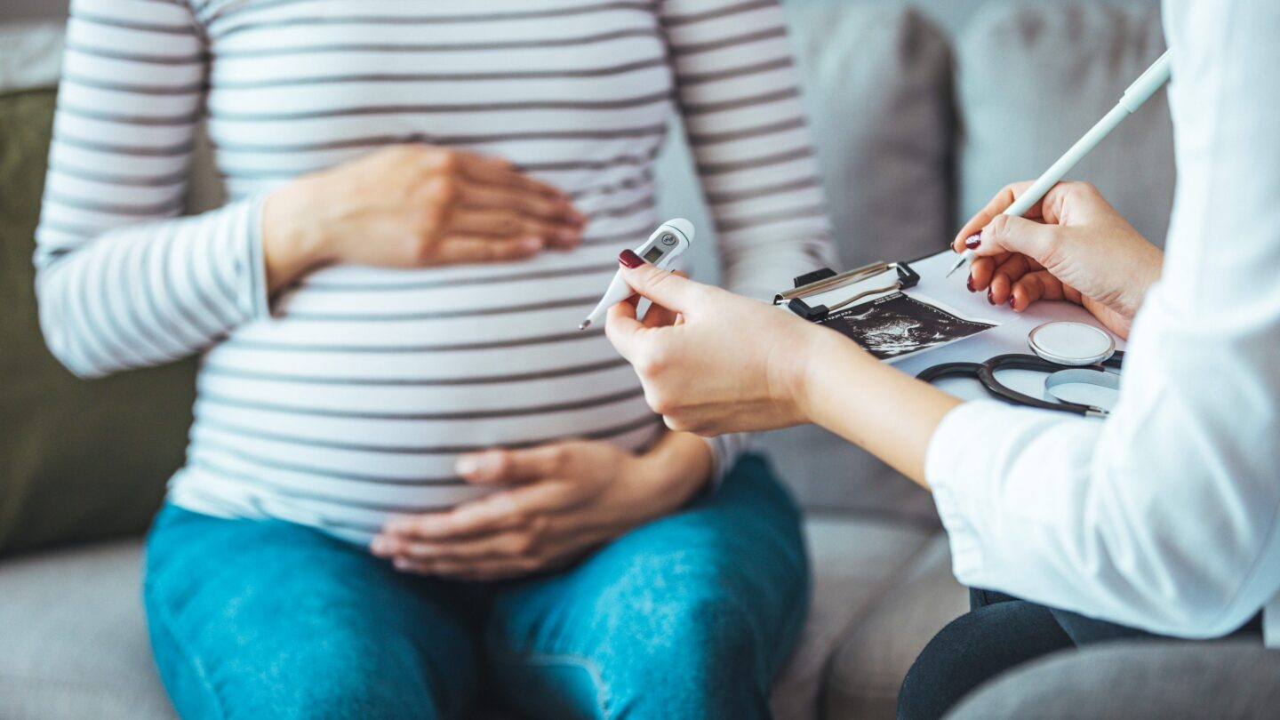 A pregnant woman during a routine check up with her doctor.