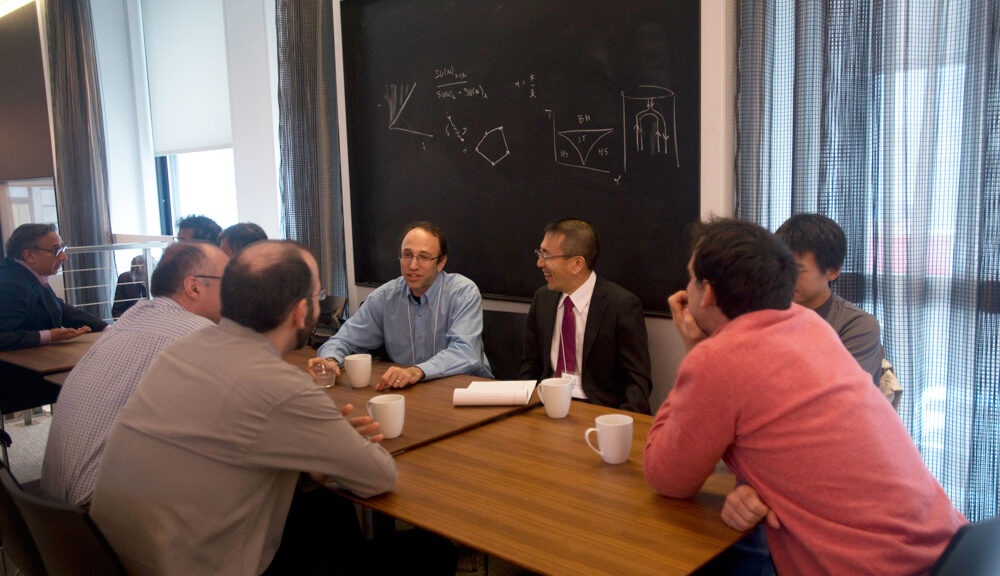 Group of people sitting at a few tables pushed together
