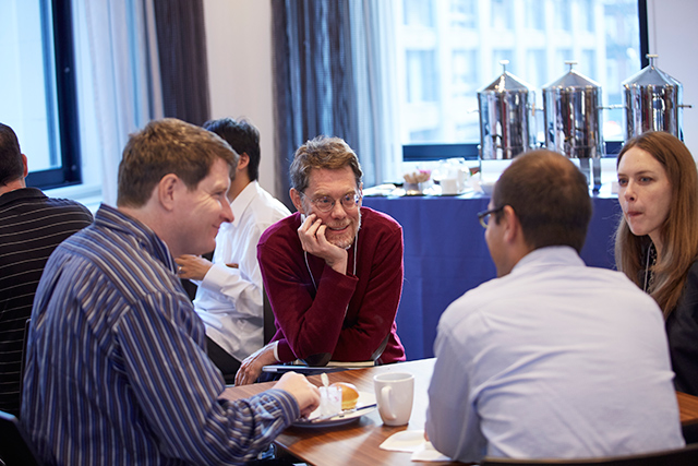 Andrew Millis at a table with three other people