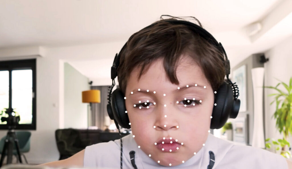 A photo of a boy using the smartphone AI app, BlinkLab, designed to support clinicians in the assessment of autism.