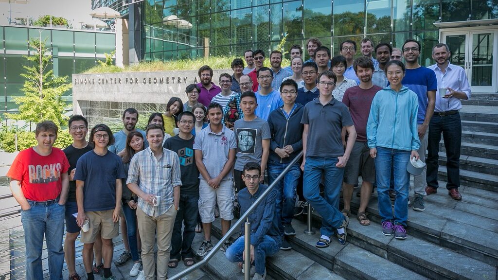 Large group of people posing on stairs of Simons Center for Geometry and Physics