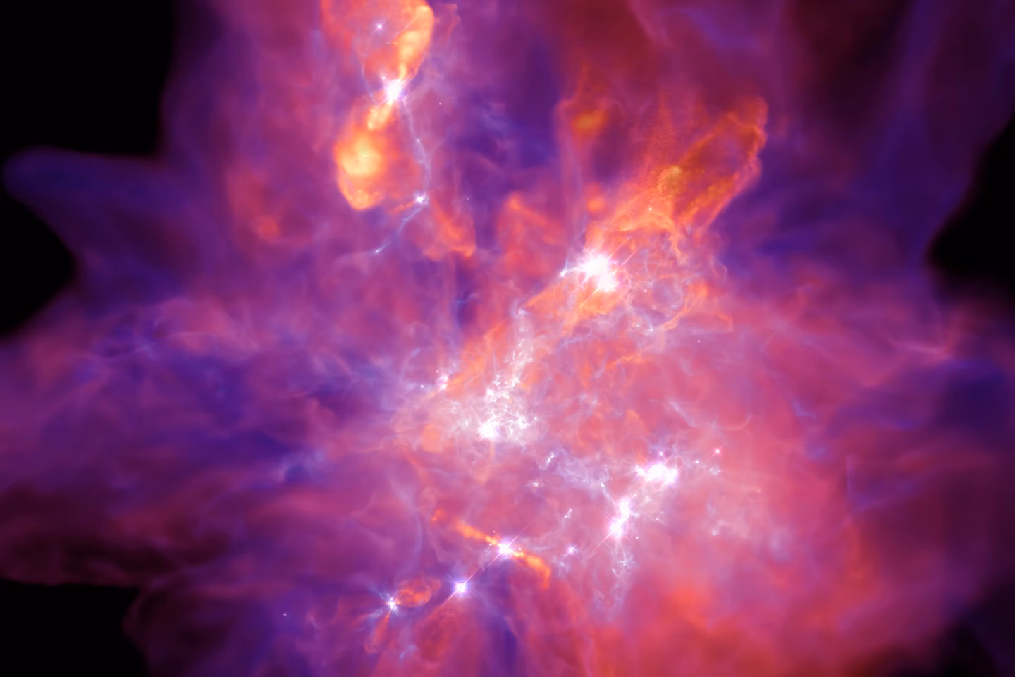 A vibrant, colorful cloud of gas and dust in space, with glowing purple, pink, and orange hues surrounding bright white light at the center, resembling a nebula.