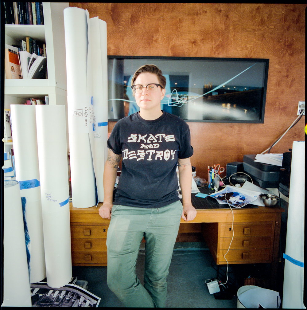 Lia Halloran standing in front of a table