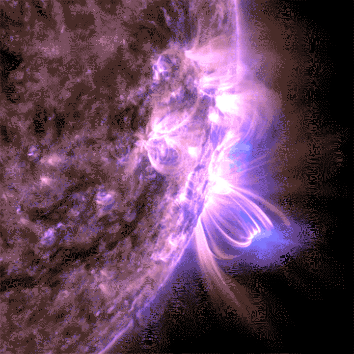 A close-up view of the sun shows swirling, bright purple and blue solar flares and magnetic arcs emanating from its surface against a dark background.