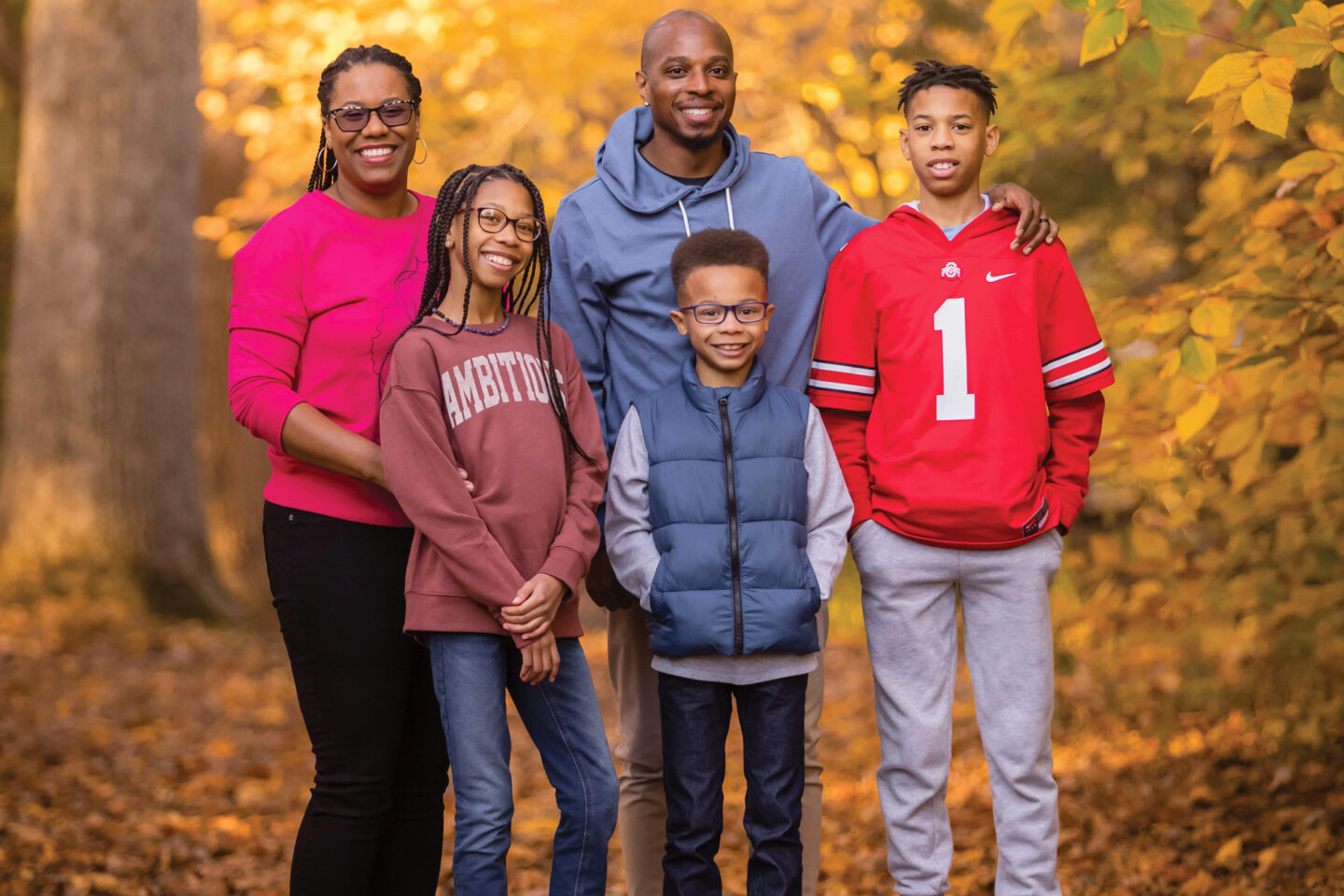 Photo of five people with trees behind them.