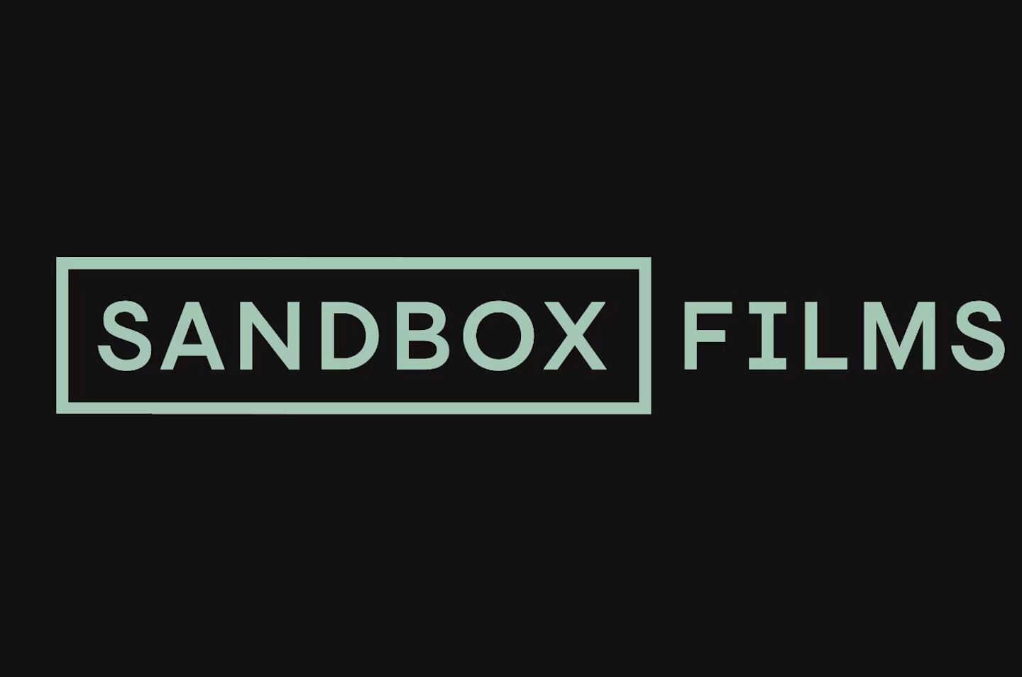 The image shows the words SANDBOX FILMS in light green capital letters on a black background. SANDBOX is enclosed in a rectangular outline.