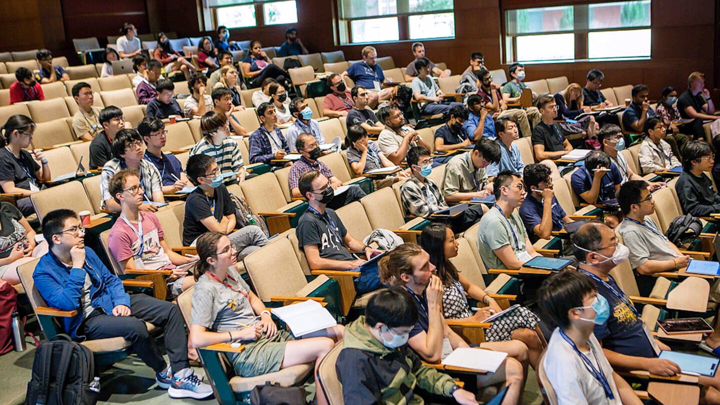 A photo of many people in an auditorium.