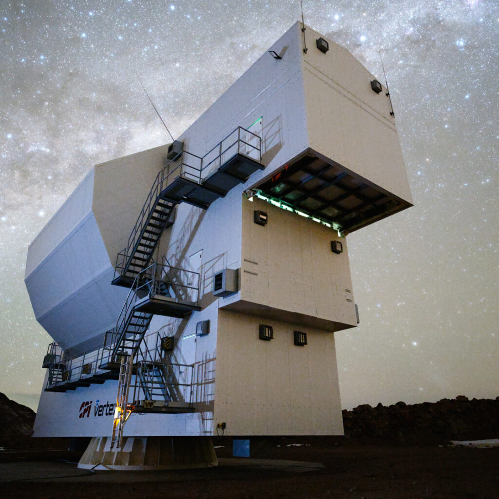 A view of Simons Observatory’s Large Aperture Telescope at night with a starry sky behind.