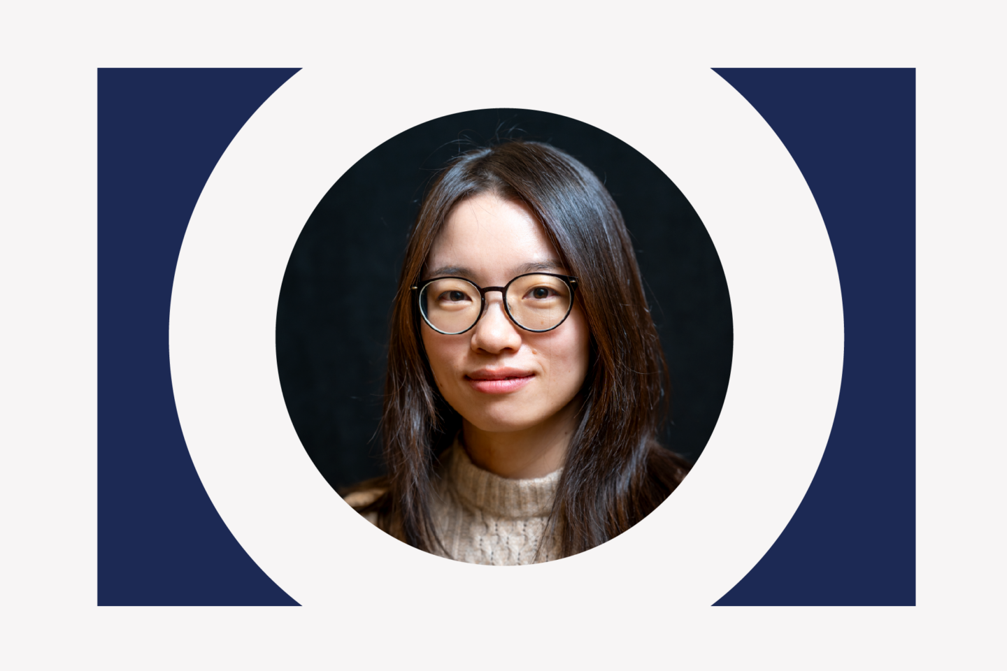Portrait of a woman with long dark hair and glasses set against a dark background within a large white circle.