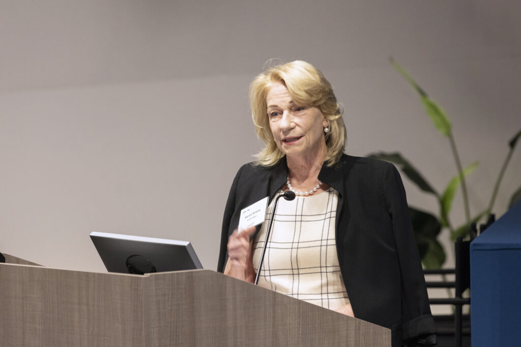Photo of Marilyn Simons Introducing the summit.
