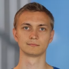 Headshot of a man with short brown hair looking at the camera.